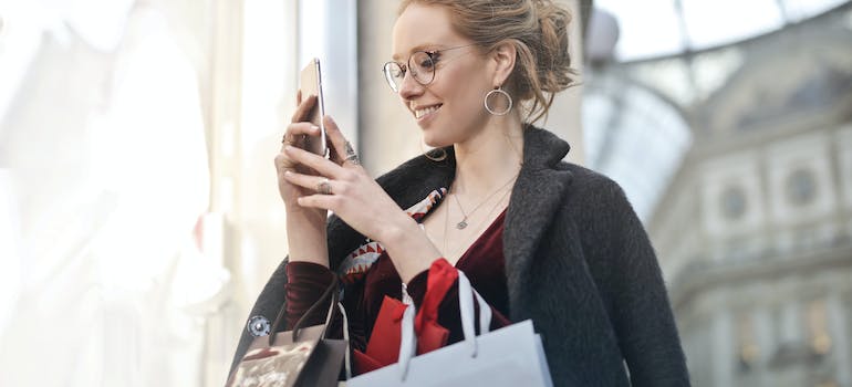 A woman taking a photo while shopping.