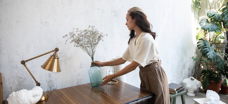 A woman decorating, one of the key ways for turning your Sudbury house into a home.