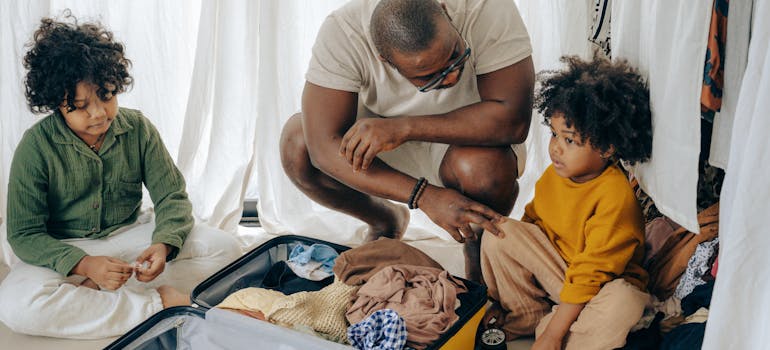 A dad packing with his kids for a vacation.