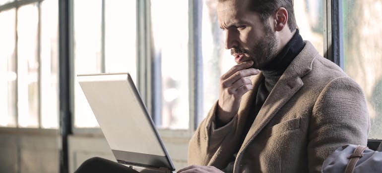 A man doing research to choose the perfect Ontario city.