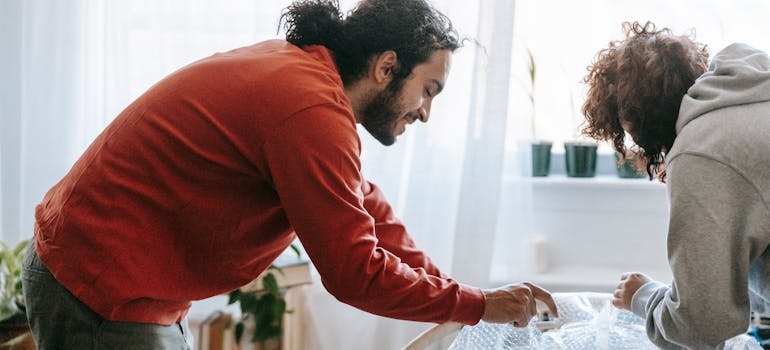 A couple preparing for the move after deciding between moving to urban or suburban areas in Ontario.