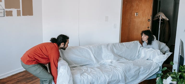 A couple preparing furniture for the move.