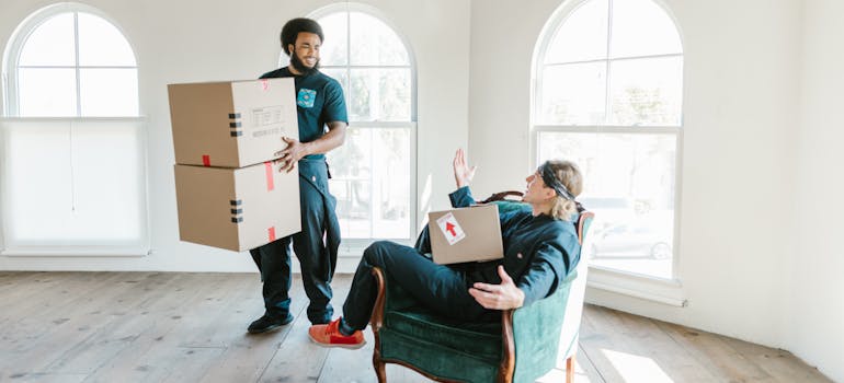 Professional movers helping someone pack after they decided between moving to urban or suburban areas in Ontario.