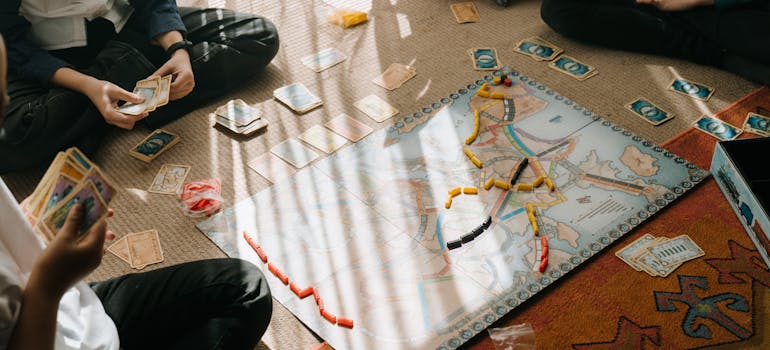 People playing board games after moving board games from Canada to the US.