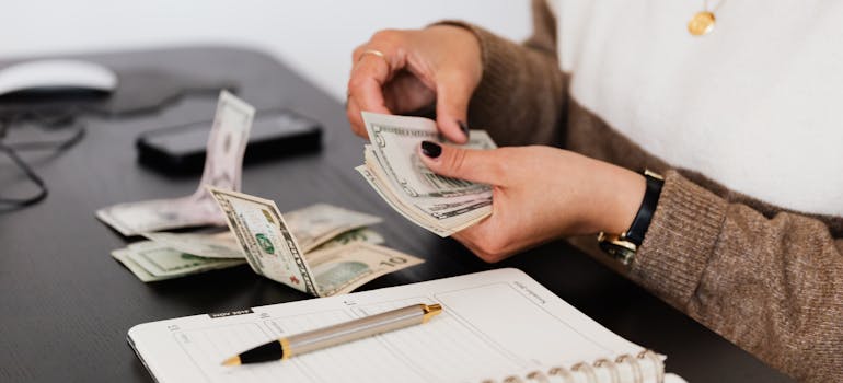 A person creating a moving budget for moving your piano to Ontario.