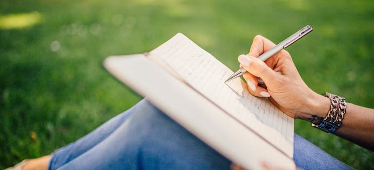 A person journaling and following self-care strategies for moving long distance.