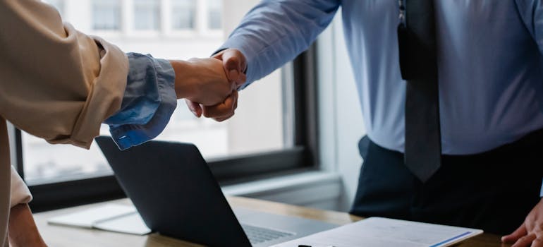People shaking hands in an office.