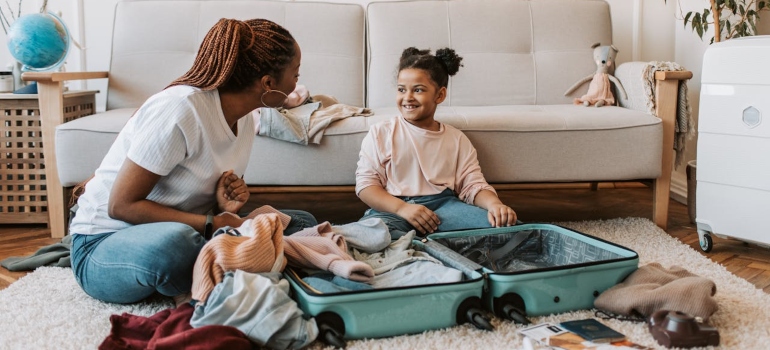 A mom and her daughter packing for a relocation.