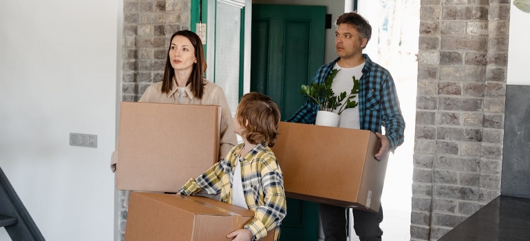 family carrying boxes