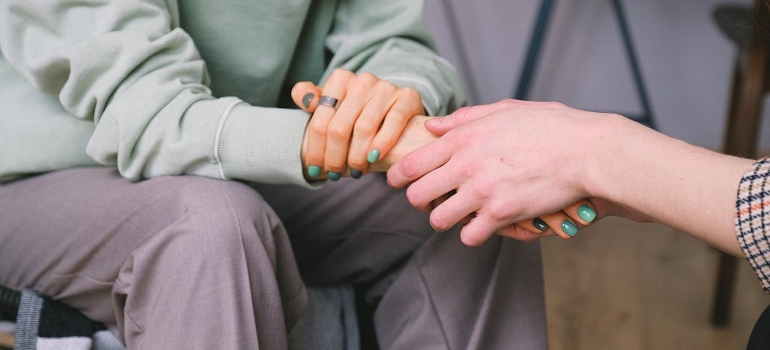 holding hands and talking how can moving to a new home help your recovery journey