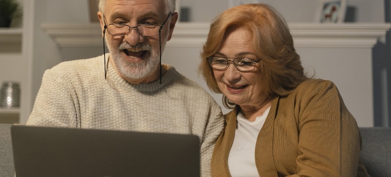 elderly couple using laptop